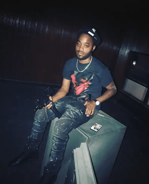 A person sitting on a suitcaseDescription automatically generated with medium confidence