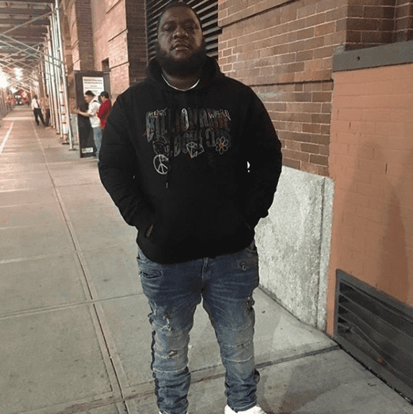 A person standing on a sidewalkDescription automatically generated with medium confidence